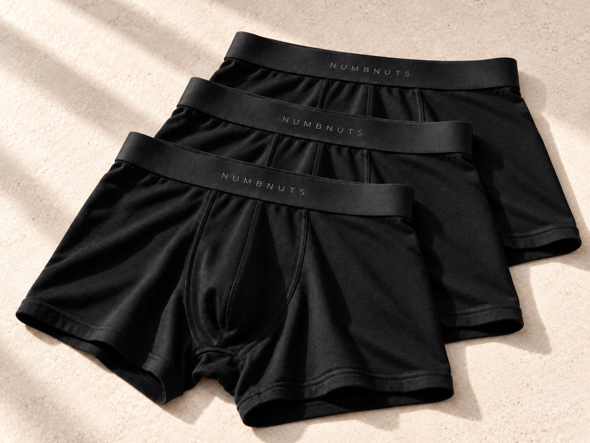 Product visualisation of three black NUMBNUTS merino-body boxers with natural-rubber waistbands. No cooling inserts.